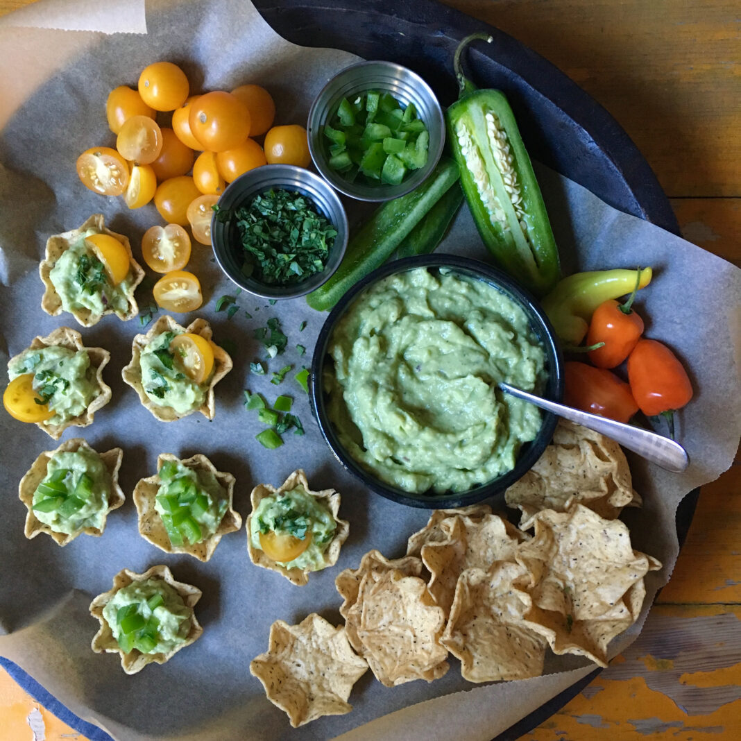 tray of creamy guacamole bites in tortilla scoops