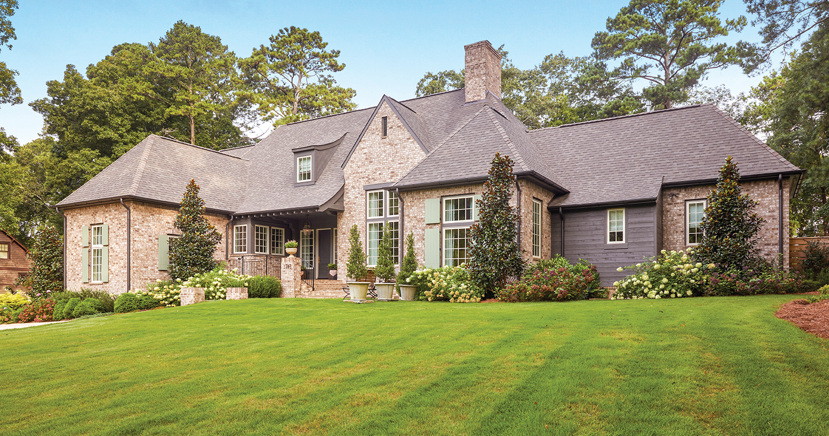 Large Homewood cottage with a clean cut lawn and fresh landscaping.