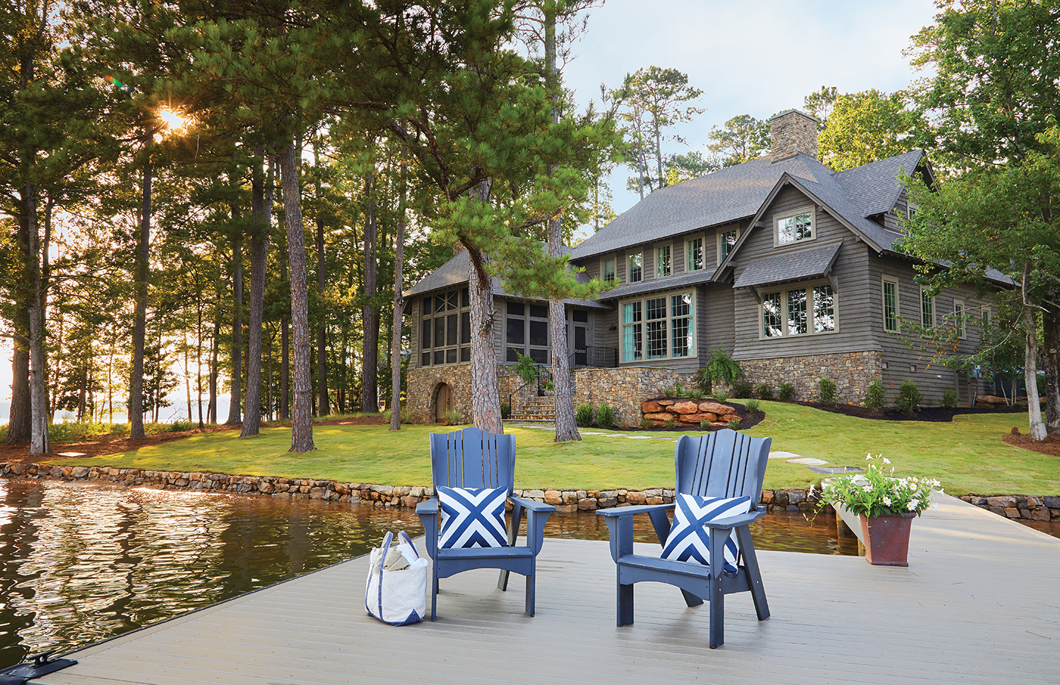 Back exterior elevation photo of large lake home.