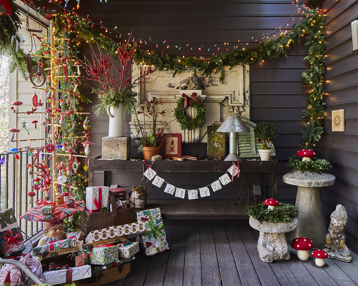 Screened in porch covered in gnomes and bright Christmas decor.